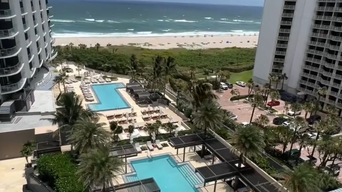 Amrit Ocean modern glass architecture with infinity pool and oceanfront landscaping