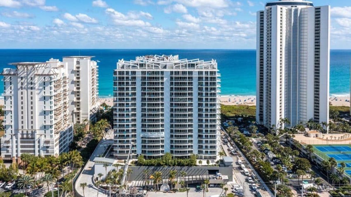 Amrit Ocean Resort and Residences twin towers with curved balconies at sunset on Singer Island beachfront